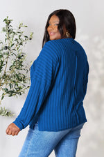 Trendsi blue ribbed knit long sleeve top worn by a woman with gold hoop earrings and light wash jeans