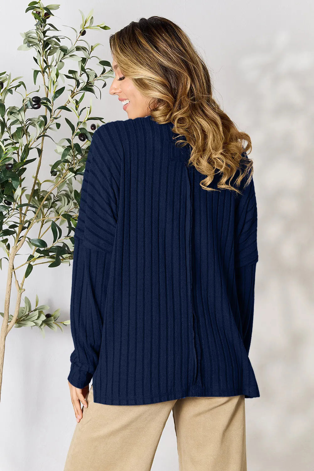 Trendsi navy blue ribbed knit long sleeve sweater worn by woman with beige pants