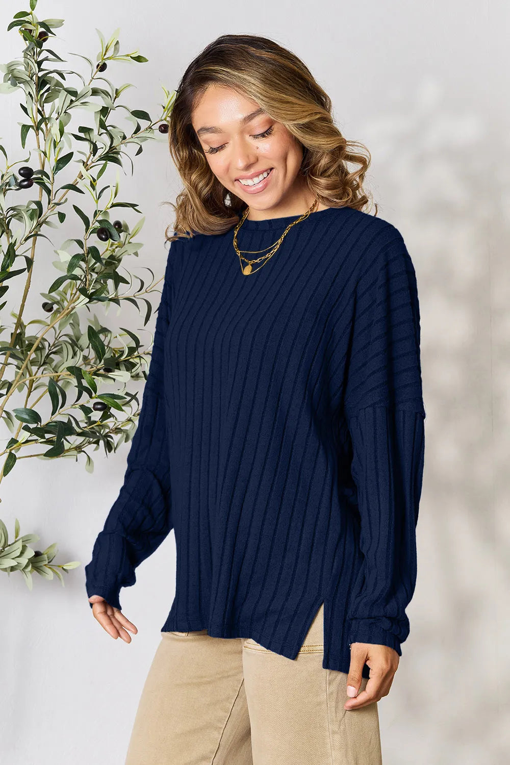 Trendsi navy blue ribbed knit long sleeve sweater with side slits worn by smiling woman