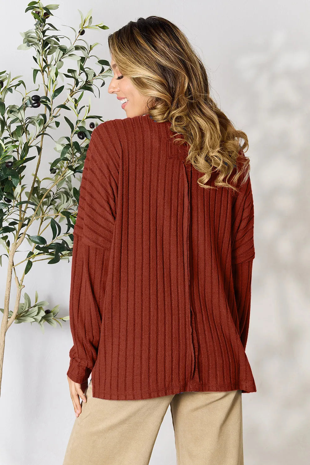 Trendsi rust-colored ribbed knit sweater with long sleeves shown from the back